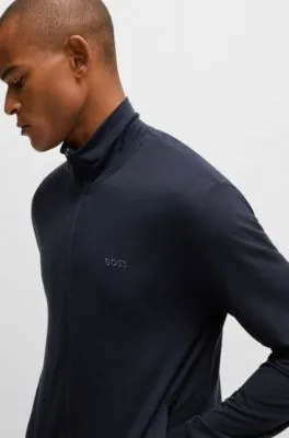Chándal relaxed fit en tejido elástico con detalles de logo