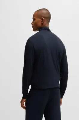 Chándal relaxed fit en tejido elástico con detalles de logo